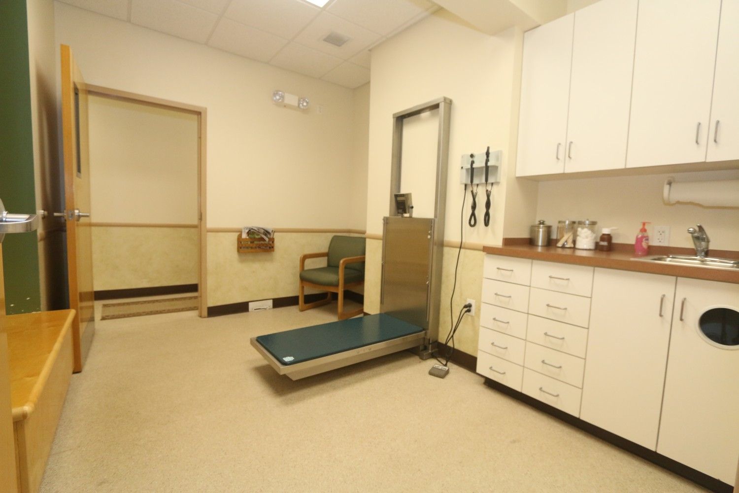 a doctor's office with a medical equipment on the floor
