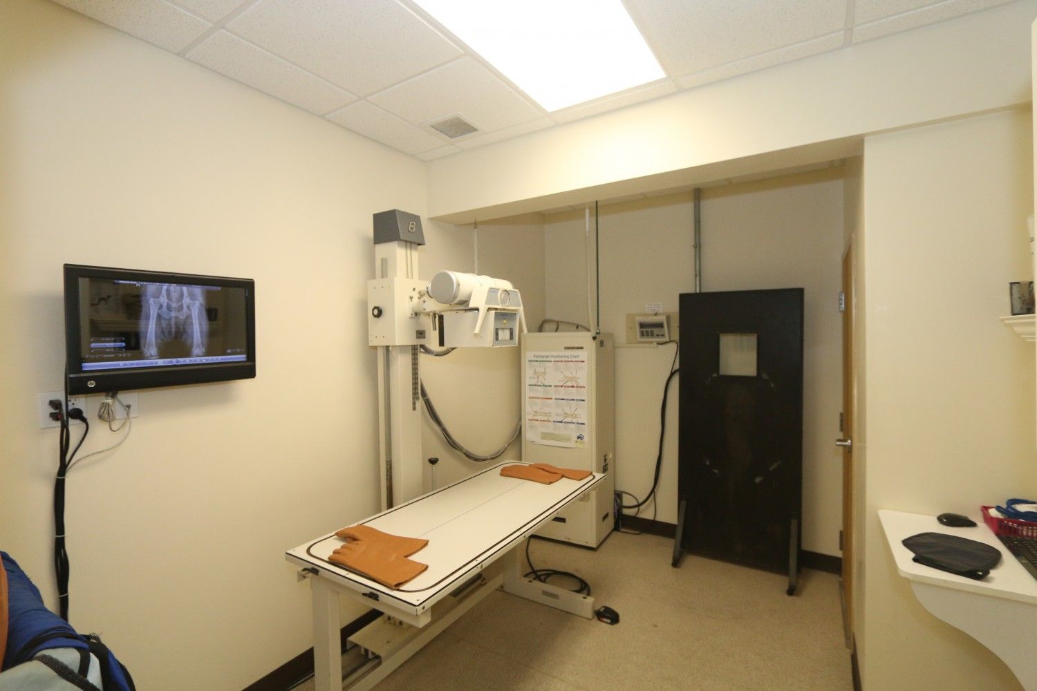 a hospital room with an x - ray machine and a television