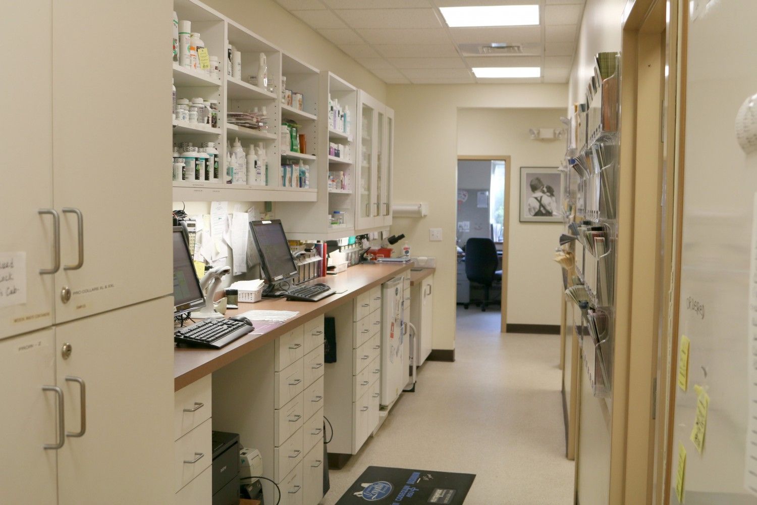 a long hallway in a medical office with lots of cabinets